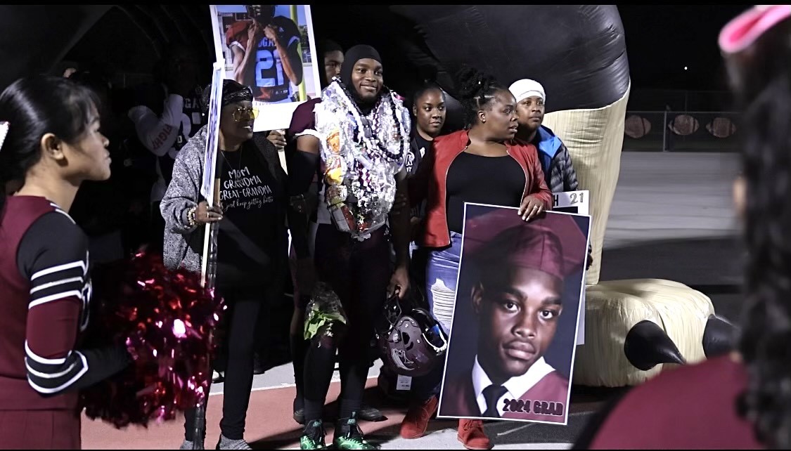 DJ poses with his family for Senior Night