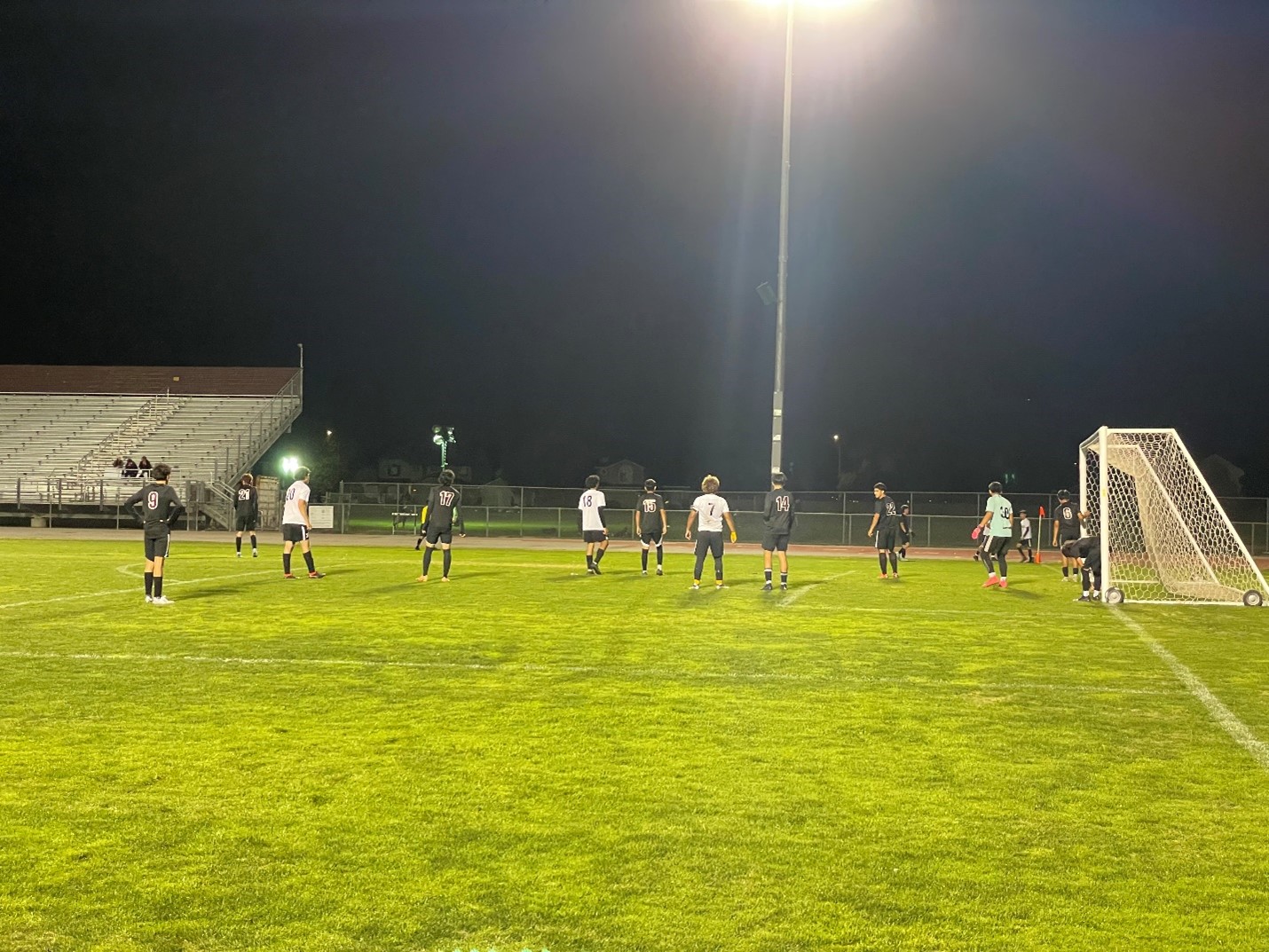 A photo of both teams getting ready for the ball to be in play.